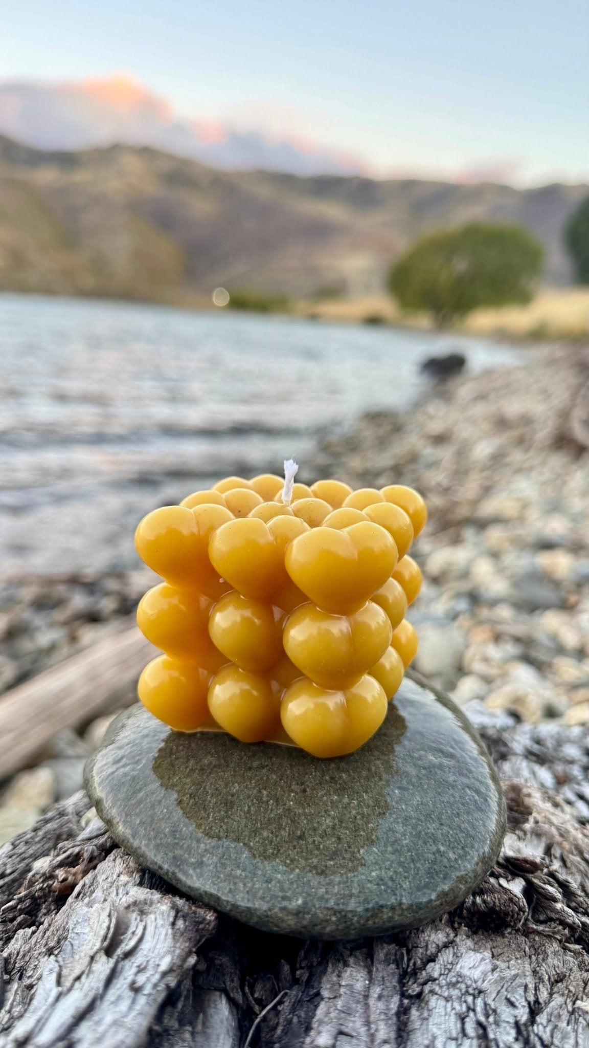 Amore Bubble 100% Beeswax Candle - Queen B Candles NZ A playful twist on the classic bubble candle, The Amore Bubble is a celebration of soft lines and romantic design. Composed of a seamless grid of miniature hearts, this sculptural candle creates a warm, inviting glow that radiates through its unique silhouette.